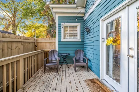 a view of balcony with two chairs and wooden floor