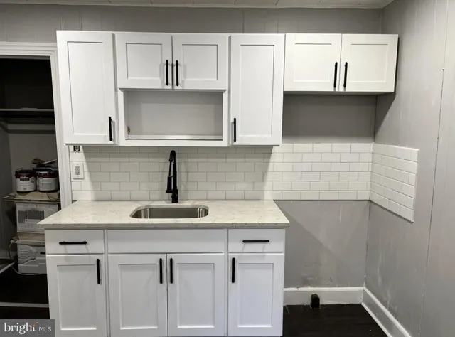 a kitchen with a sink and cabinets