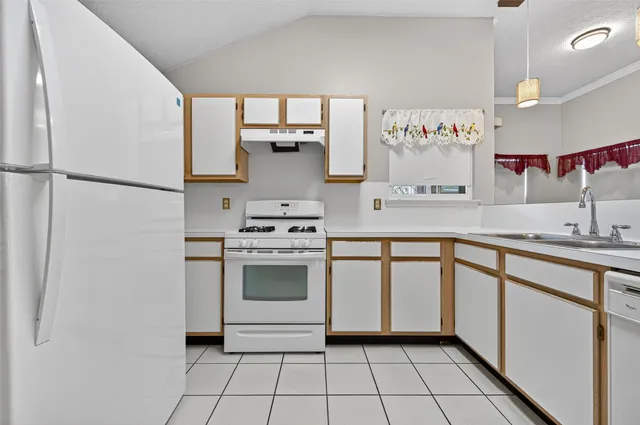 a kitchen with stainless steel appliances a stove a sink and a refrigerator