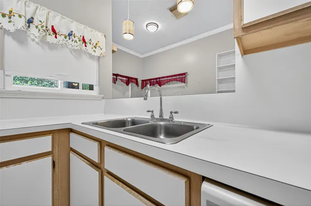 a kitchen with a sink and a refrigerator