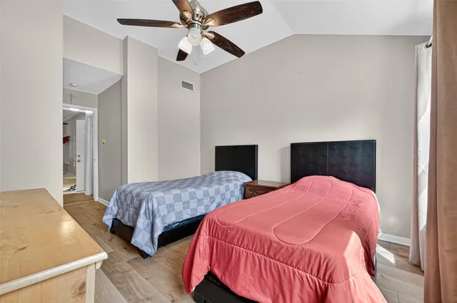 a bedroom with two beds and painting on the wall