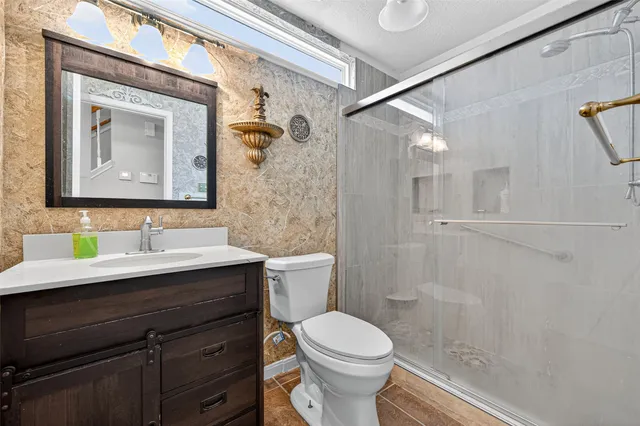 a bathroom with a toilet a sink and mirror