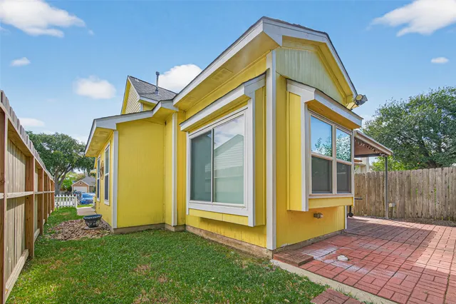 a view of a house with wooden fence