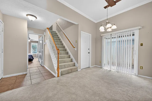 en view interior of a house with stairs and a ceiling fan