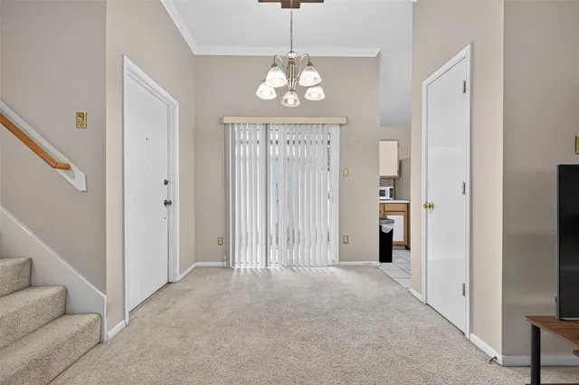 a view of a chandelier in a hall with an entryway
