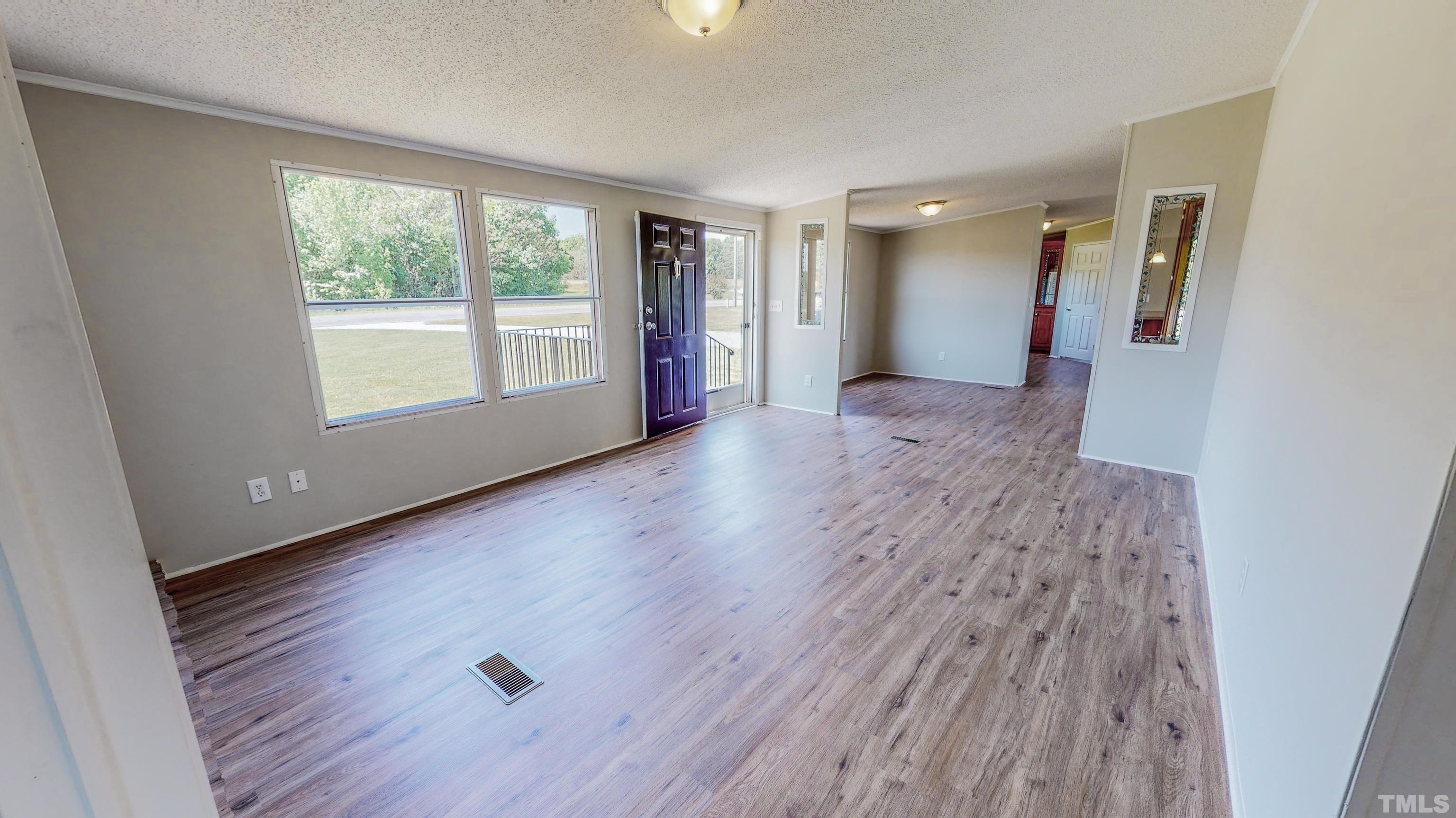 552 Huff Road Roxboro, NC 27574 - Photo 25 of 43 an empty room with wooden floor and windows