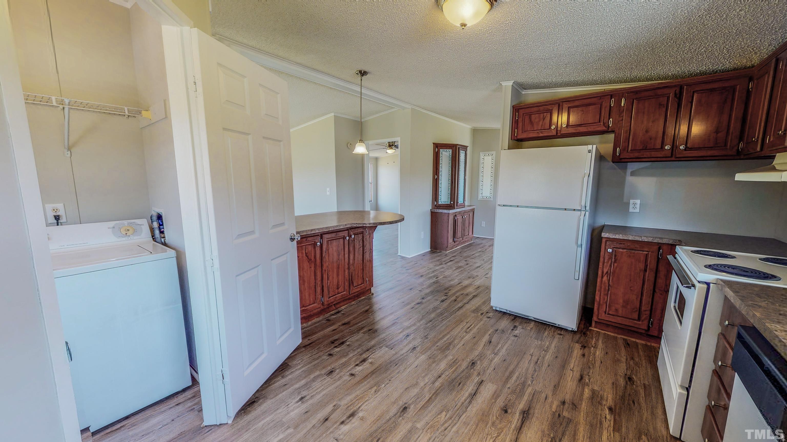 552 Huff Road Roxboro, NC 27574 - Photo 28 of 43 a kitchen with a refrigerator a stove and wooden floor