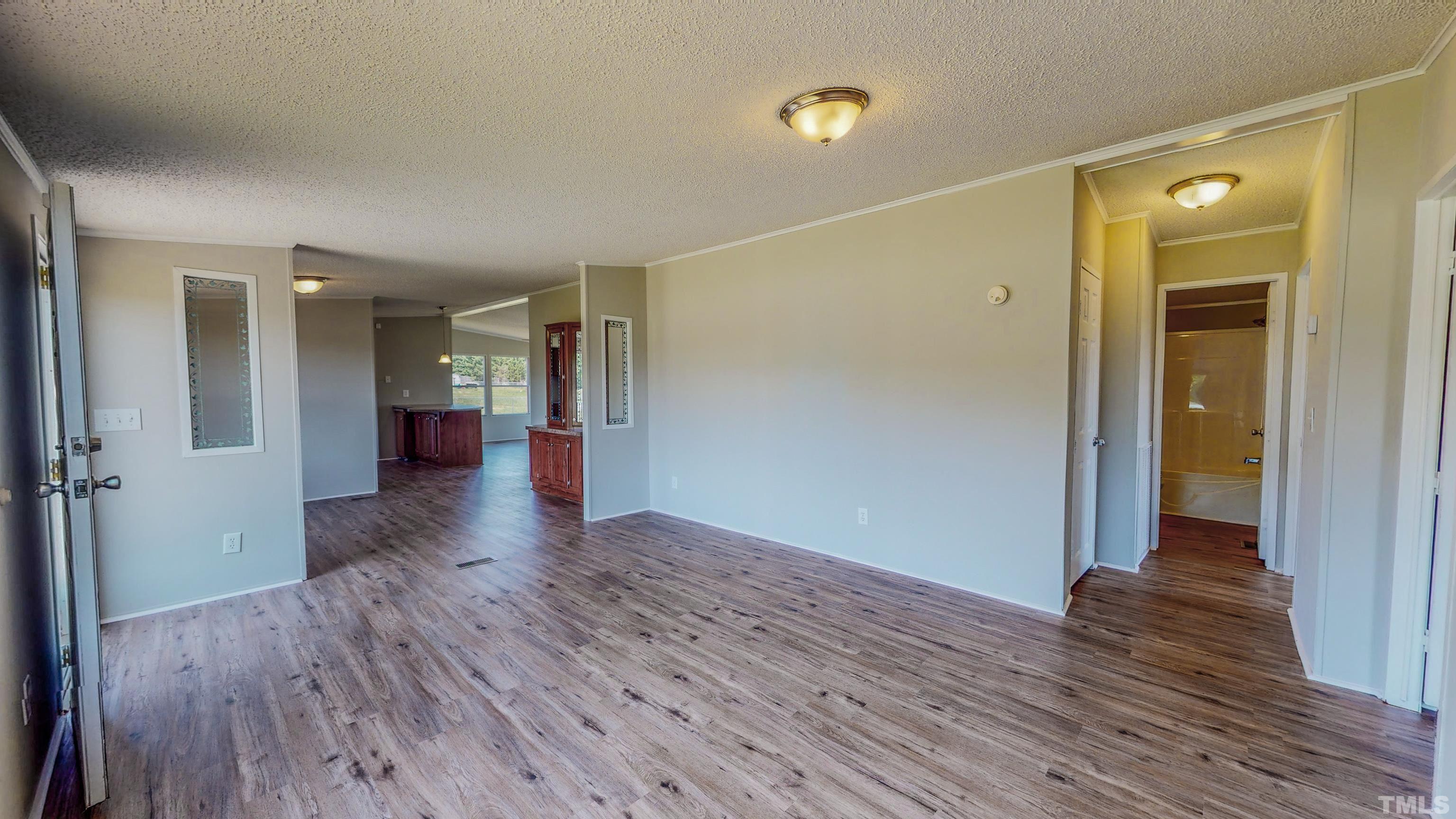 552 Huff Road Roxboro, NC 27574 - Photo 3 of 43 wooden floor in an empty room with a window