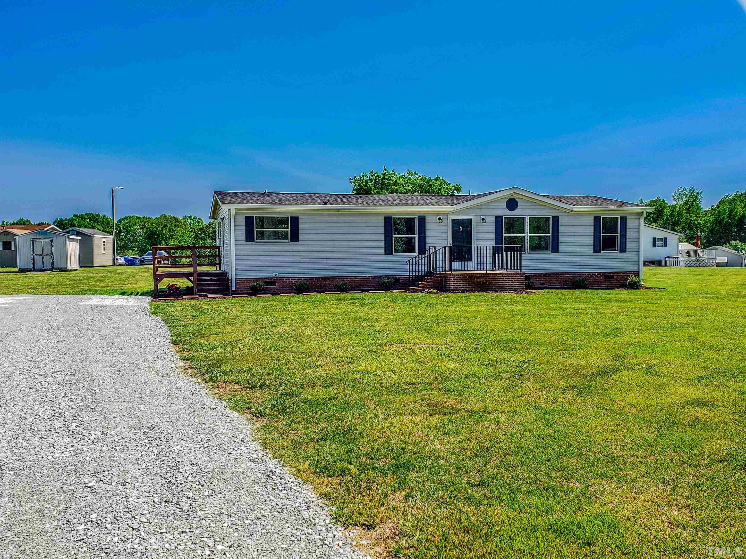 552 Huff Road Roxboro, NC 27574 - Photo 36 of 43 a view of a house with a big yard and palm trees