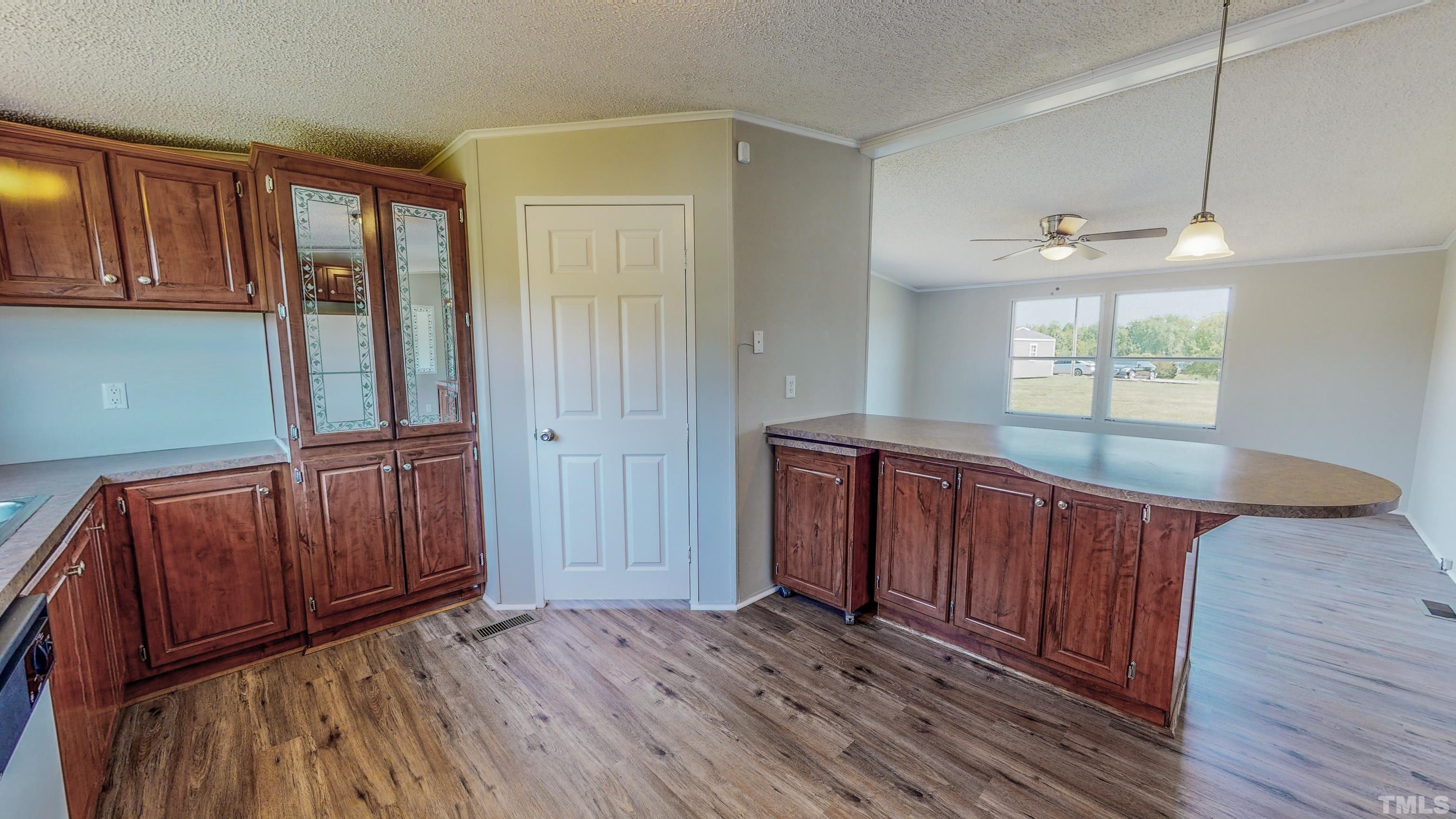552 Huff Road Roxboro, NC 27574 - Photo 7 of 43 an empty room with wooden floor and windows