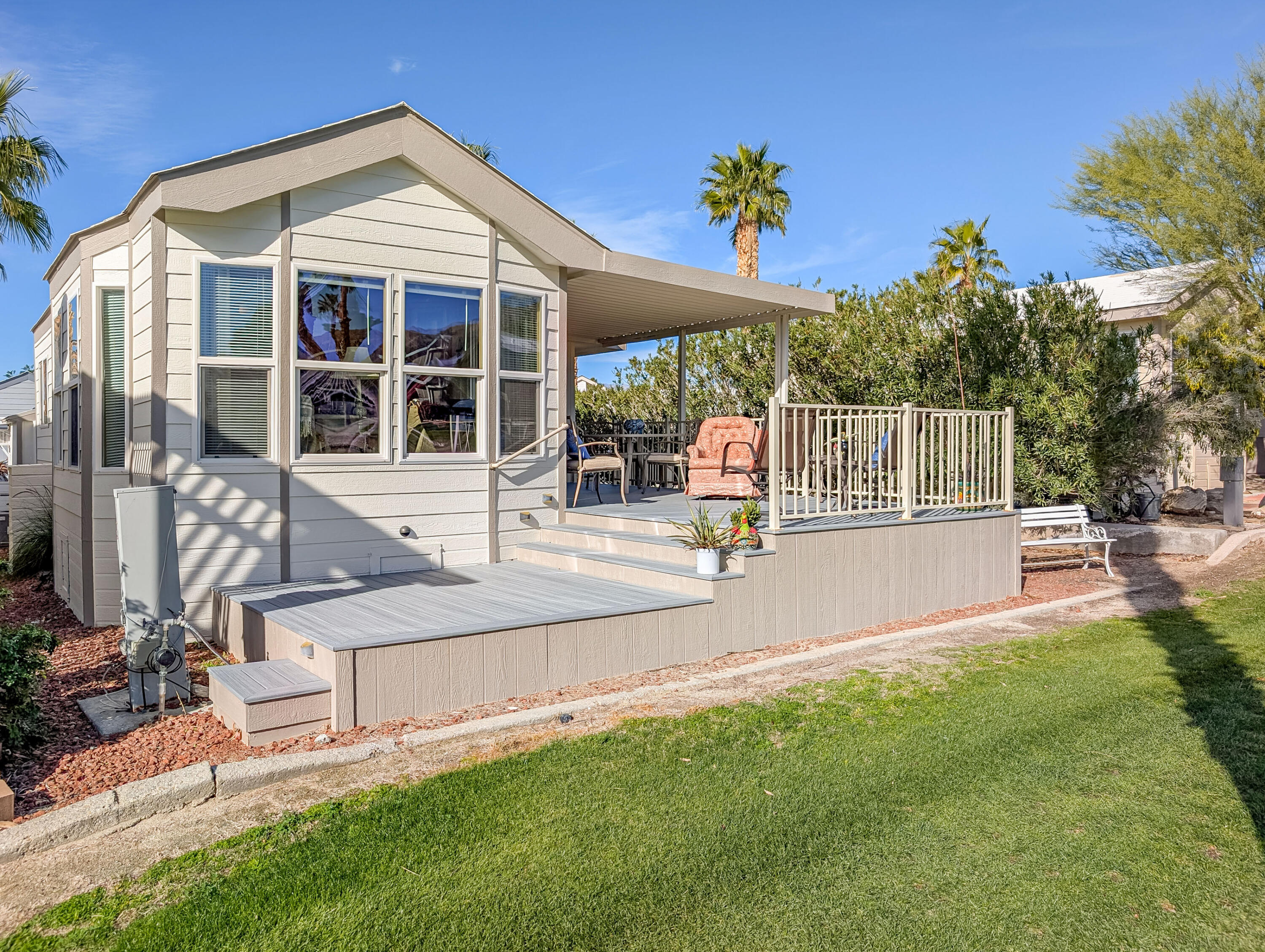 70200 Dillon Road, Unit 590 Desert Hot Springs, CA 92241 - Photo 17 of 42 a view of a house with a swimming pool