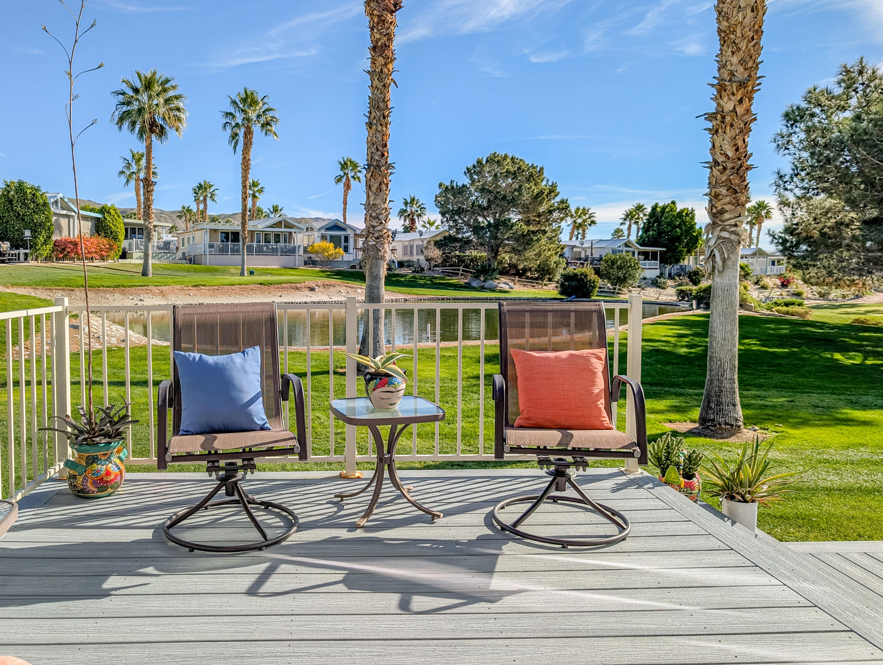 70200 Dillon Road, Unit 590 Desert Hot Springs, CA 92241 - Photo 19 of 42 a view of a swimming pool with a table and chairs