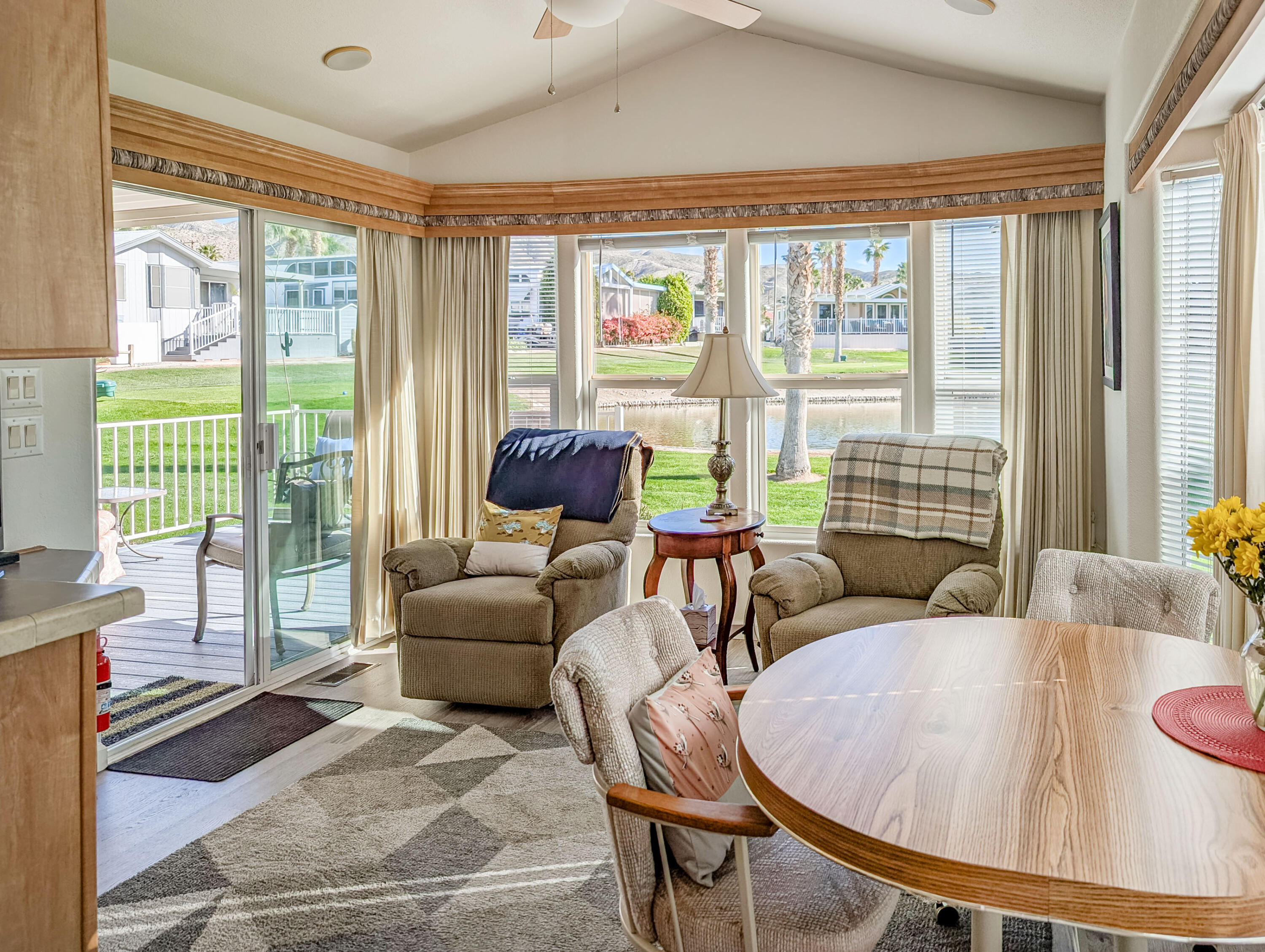 70200 Dillon Road, Unit 590 Desert Hot Springs, CA 92241 - Photo 20 of 42 a living room with furniture and a floor to ceiling window