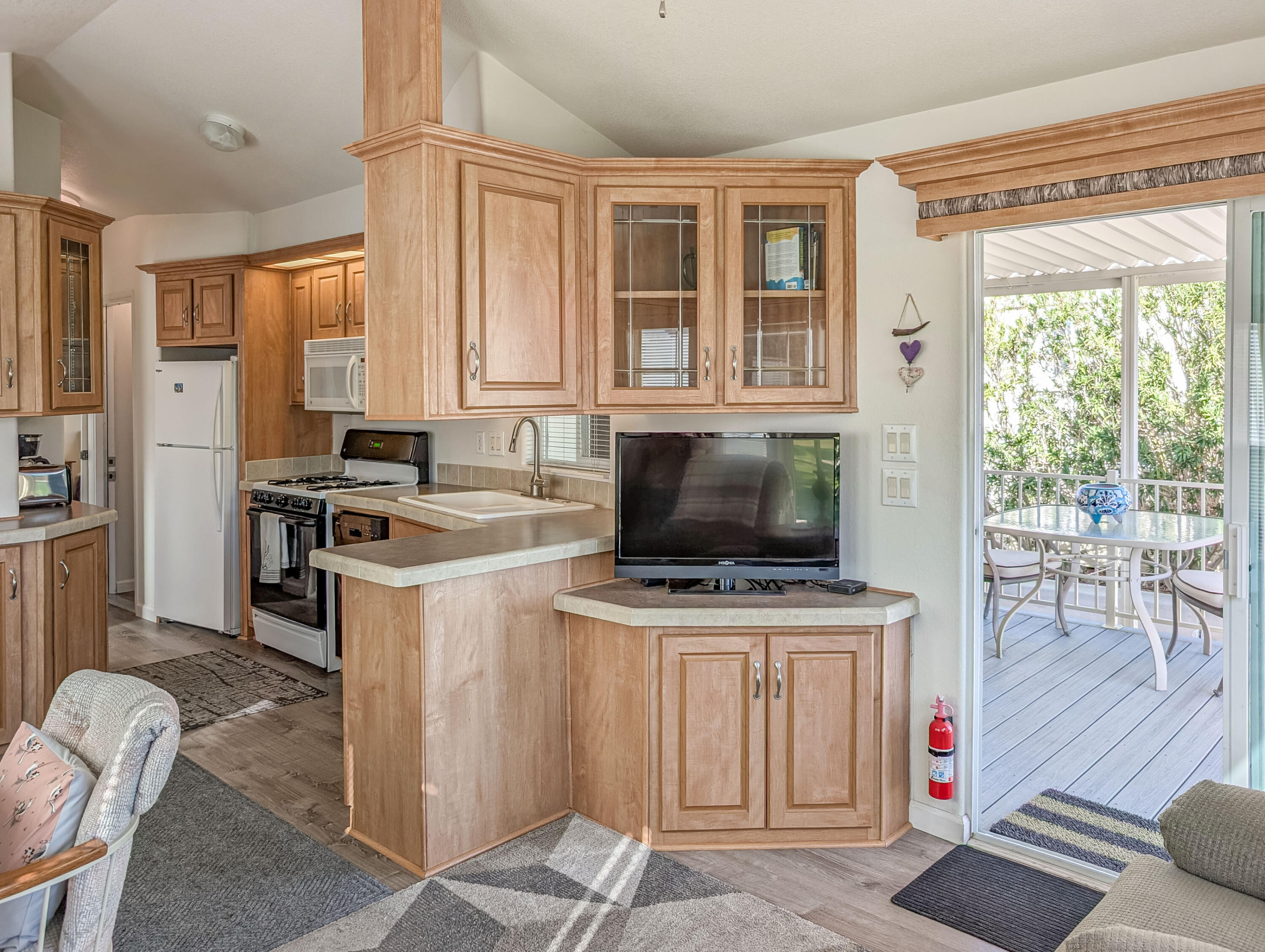 70200 Dillon Road, Unit 590 Desert Hot Springs, CA 92241 - Photo 22 of 42 a kitchen with stainless steel appliances a stove a sink and a refrigerator