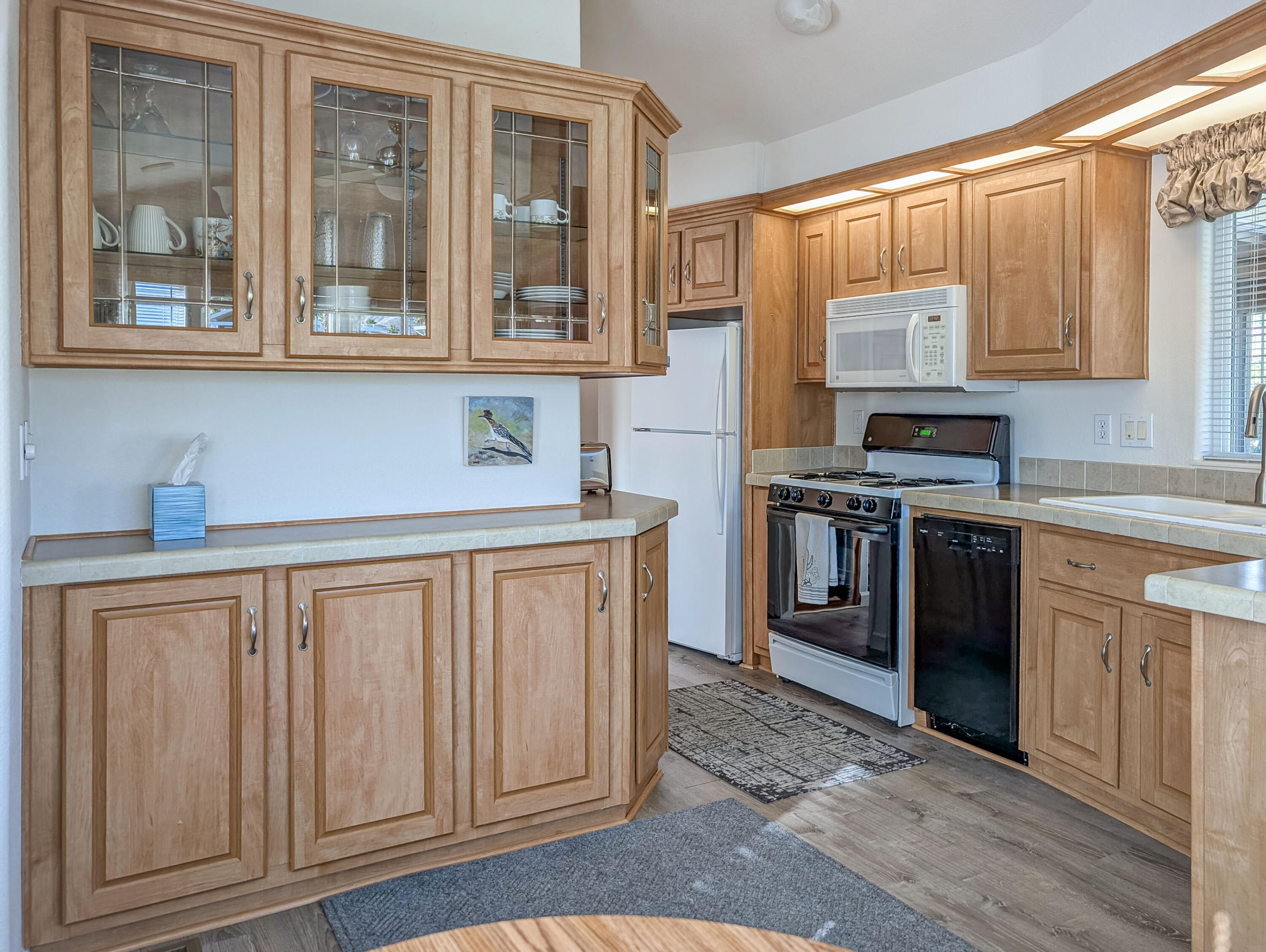 70200 Dillon Road, Unit 590 Desert Hot Springs, CA 92241 - Photo 24 of 42 a kitchen with stainless steel appliances granite countertop a stove a sink and a refrigerator