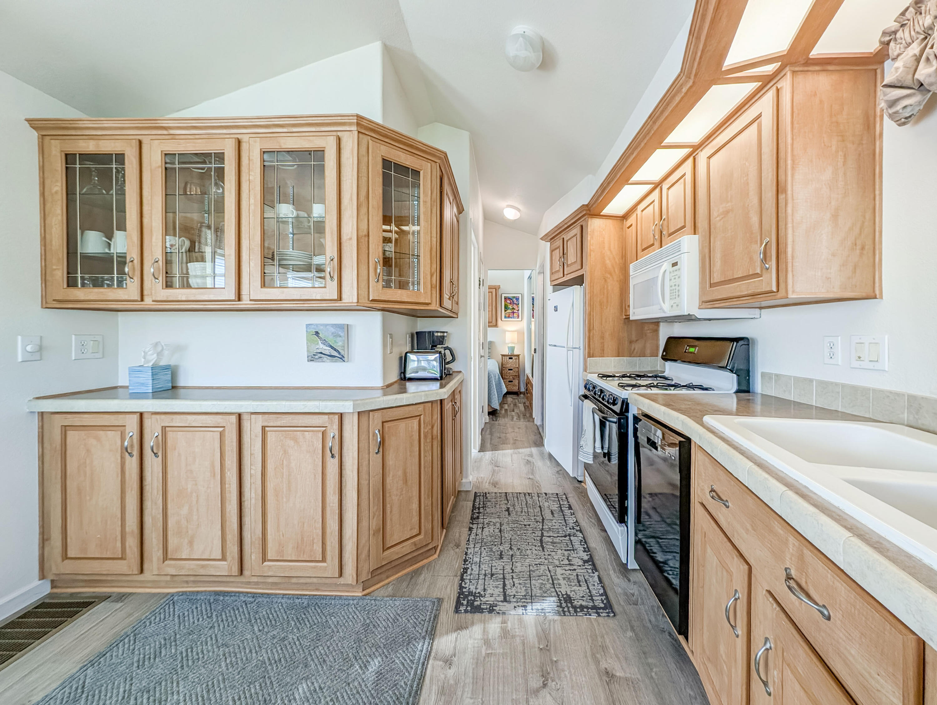 70200 Dillon Road, Unit 590 Desert Hot Springs, CA 92241 - Photo 26 of 42 a kitchen with stainless steel appliances granite countertop a refrigerator and a sink