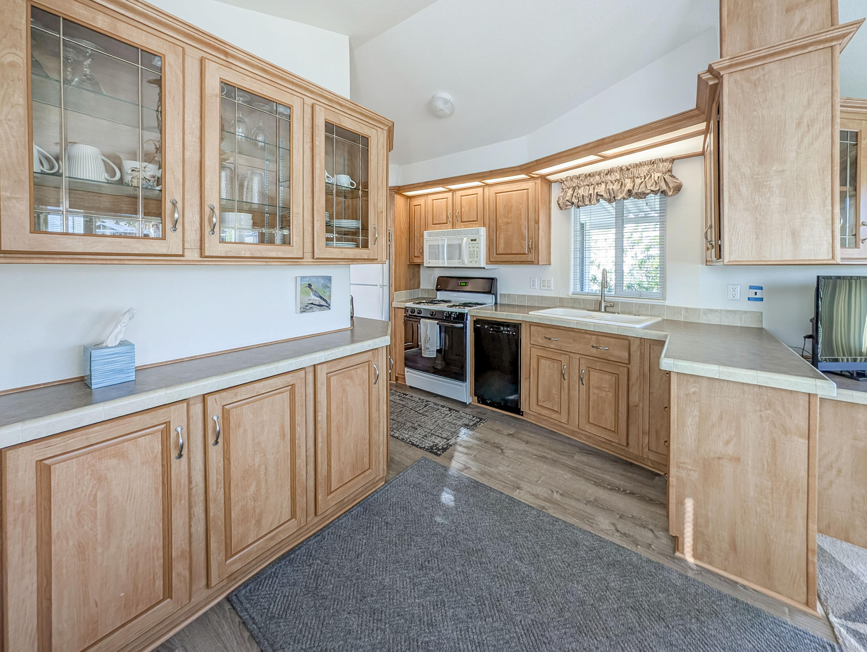 70200 Dillon Road, Unit 590 Desert Hot Springs, CA 92241 - Photo 27 of 42 a kitchen with stainless steel appliances granite countertop a stove sink and cabinets