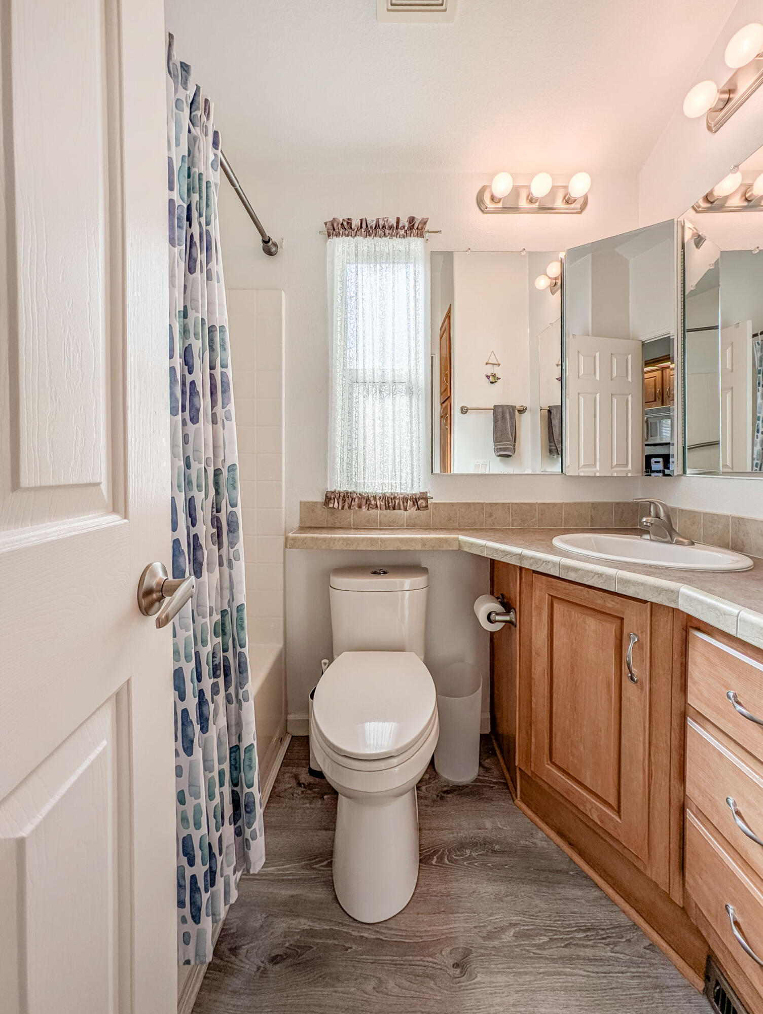 70200 Dillon Road, Unit 590 Desert Hot Springs, CA 92241 - Photo 29 of 42 a bathroom with a granite countertop toilet sink and mirror