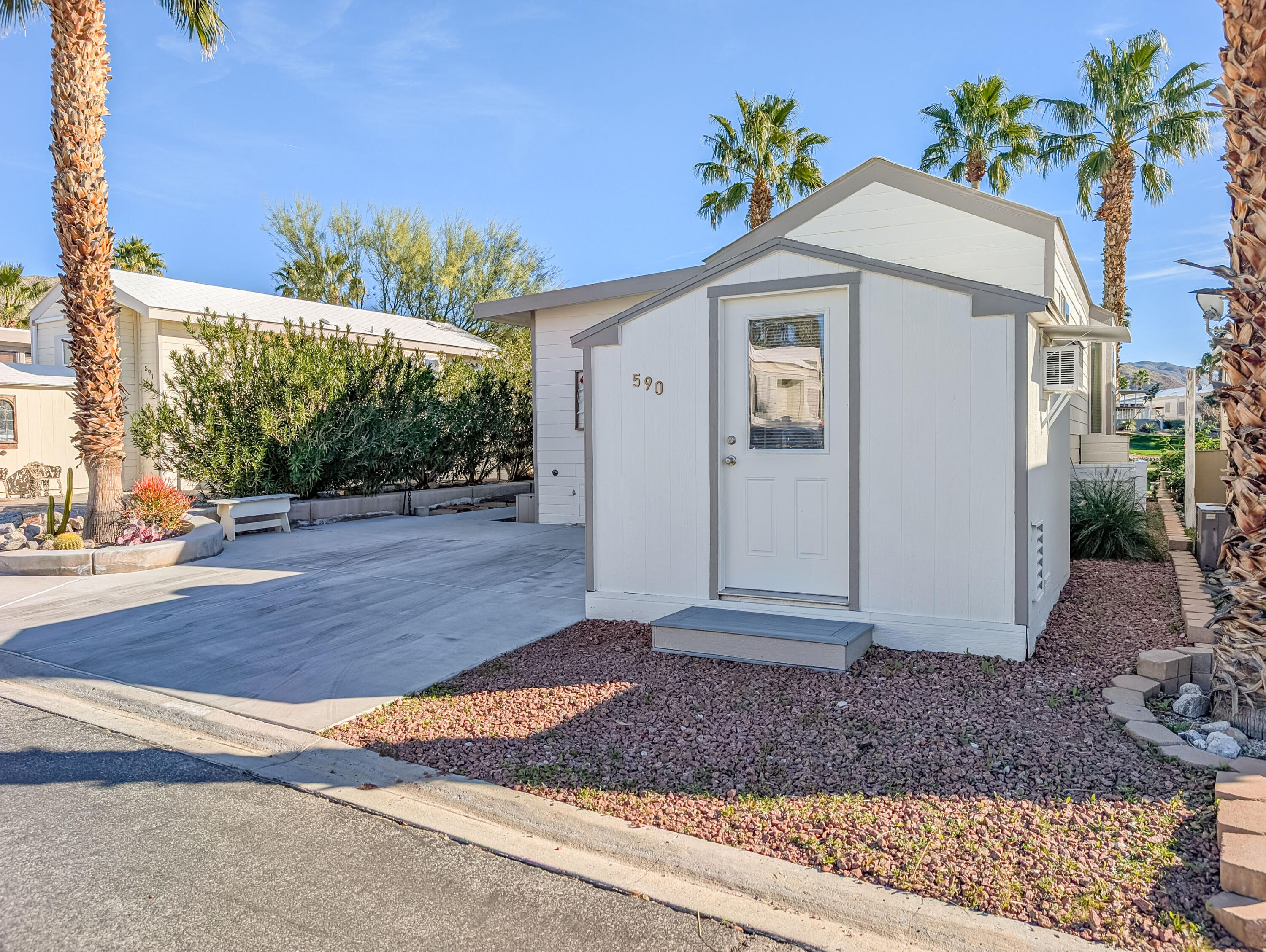 70200 Dillon Road, Unit 590 Desert Hot Springs, CA 92241 - Photo 3 of 42 a front view of a house with garden