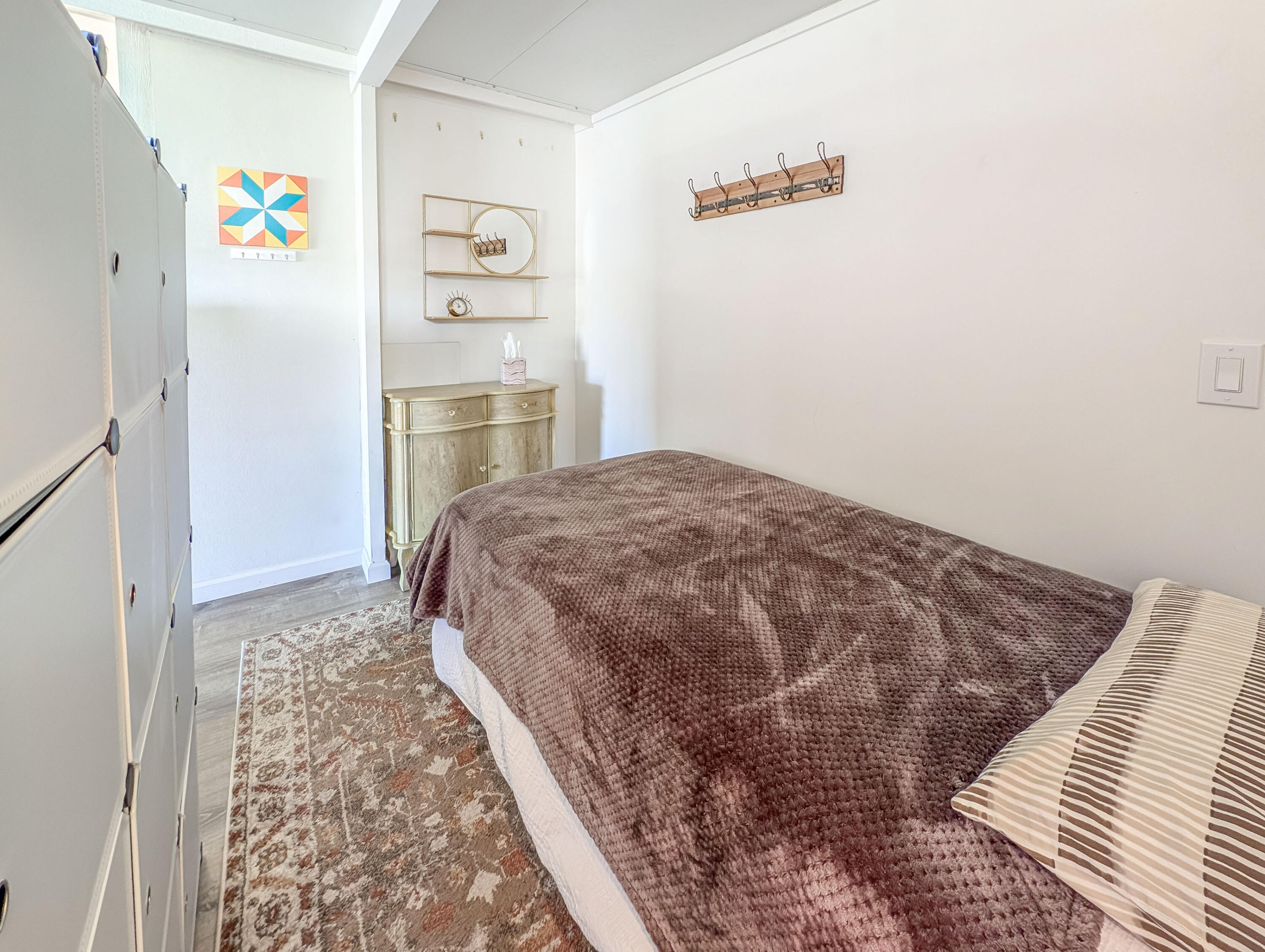 70200 Dillon Road, Unit 590 Desert Hot Springs, CA 92241 - Photo 39 of 42 a bedroom with a bed and a refrigerator