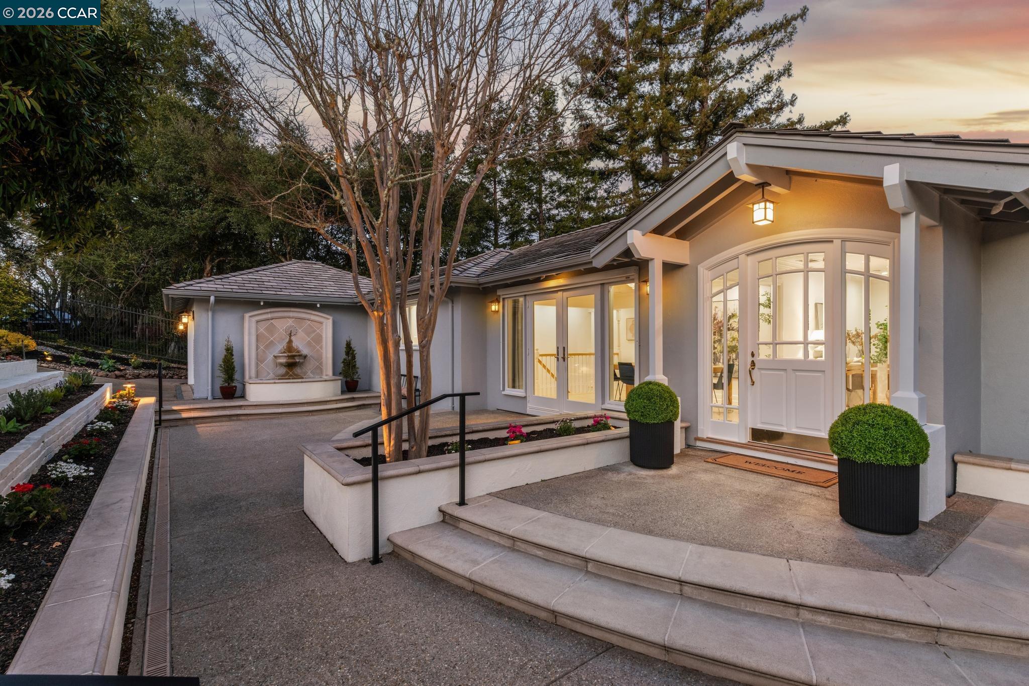a view of a house with sitting area and garden