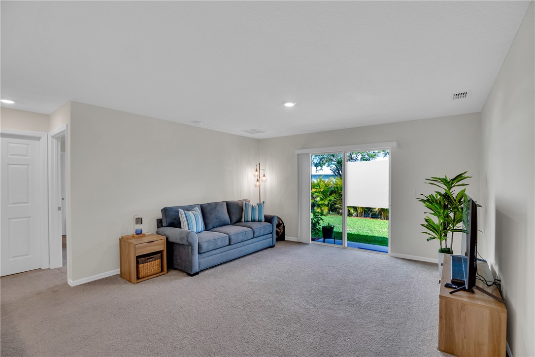 938 Clearmont Street Sebastian, FL 32958 - Photo 15 of 36 a living room with furniture and a potted plant