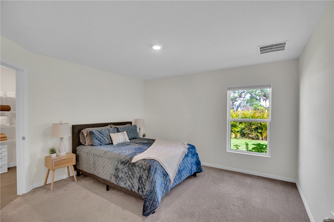 938 Clearmont Street Sebastian, FL 32958 - Photo 18 of 36 a bedroom with a bed and a window