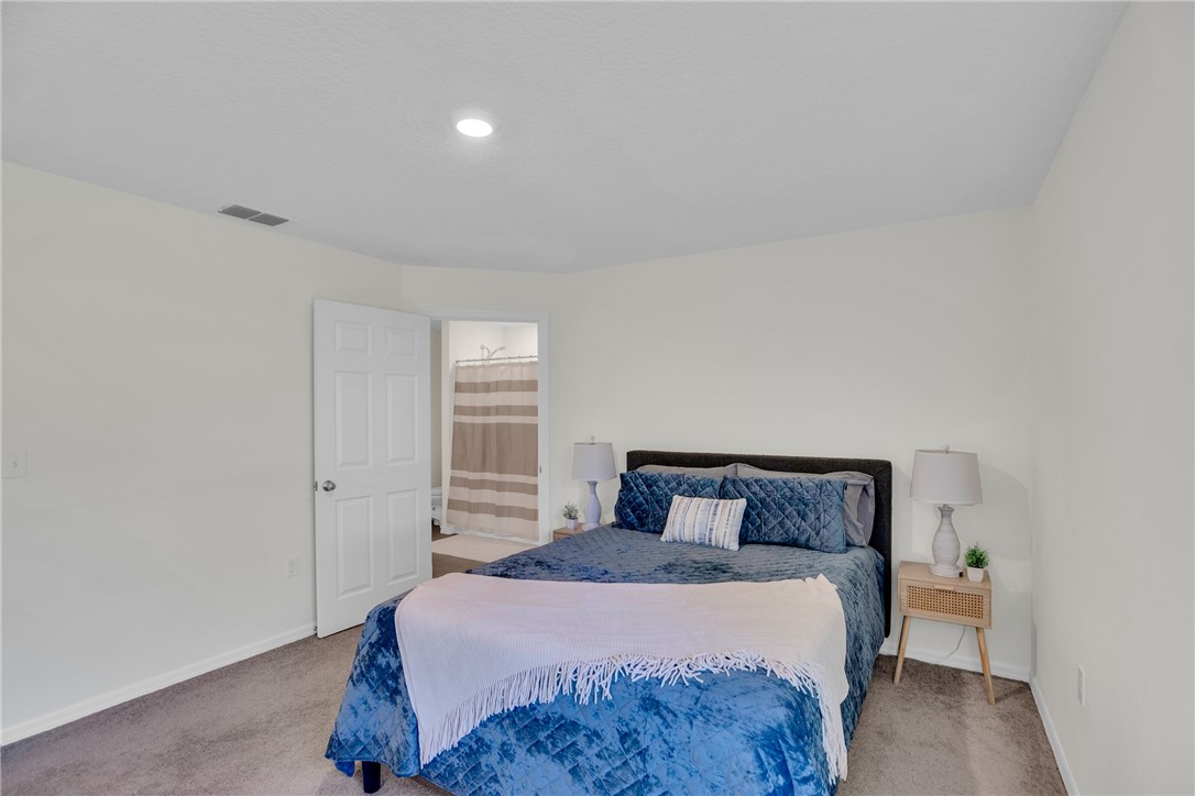 938 Clearmont Street Sebastian, FL 32958 - Photo 19 of 36 a bedroom with a bed and window