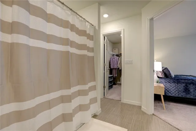 a living room with a couch and a walk in closet