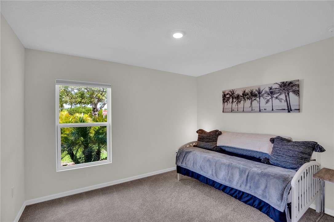 938 Clearmont Street Sebastian, FL 32958 - Photo 26 of 36 a bedroom with a bed and a painting on the wall