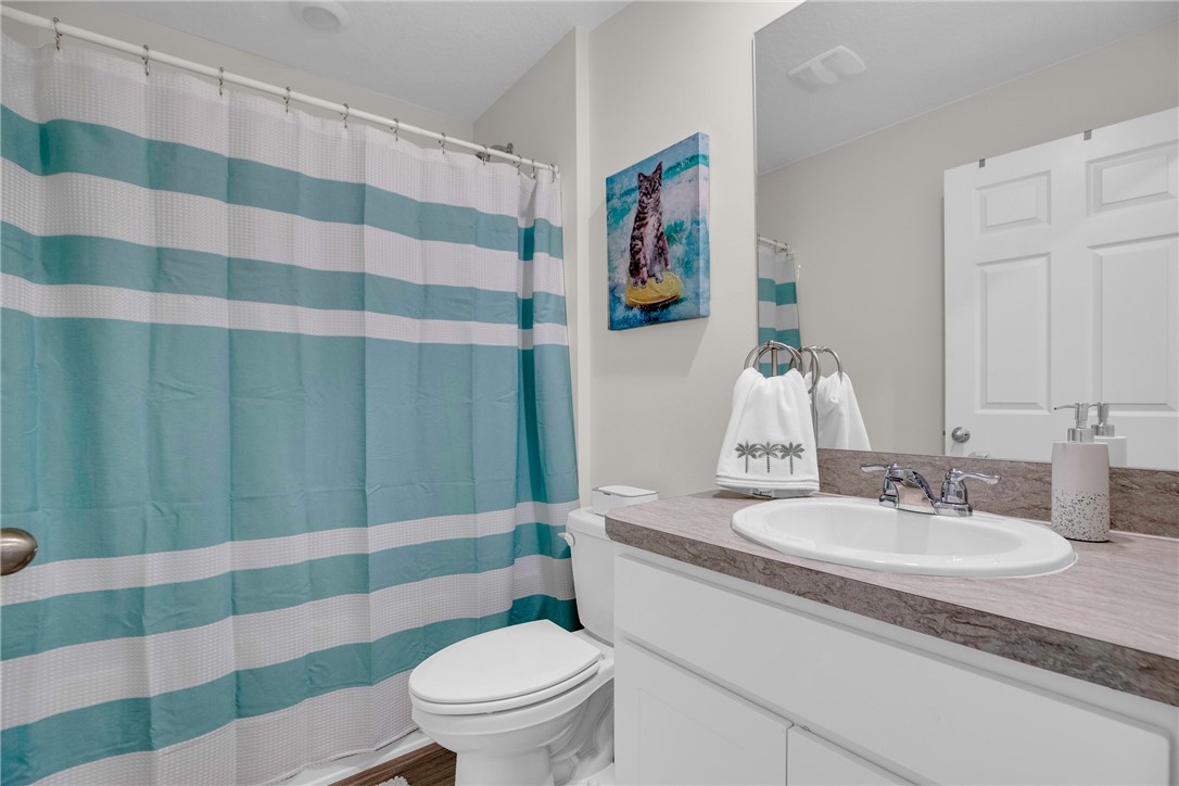 938 Clearmont Street Sebastian, FL 32958 - Photo 28 of 36 a bathroom with a sink toilet and shower