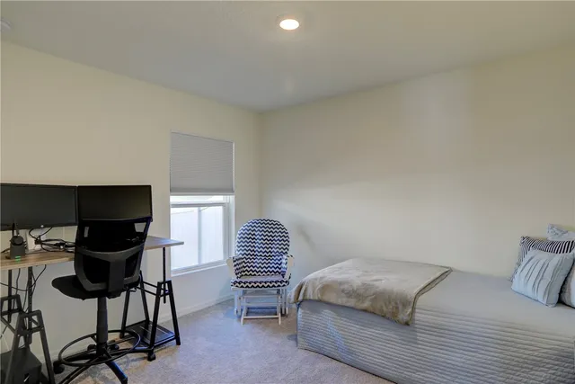 a bedroom with a bed and chair