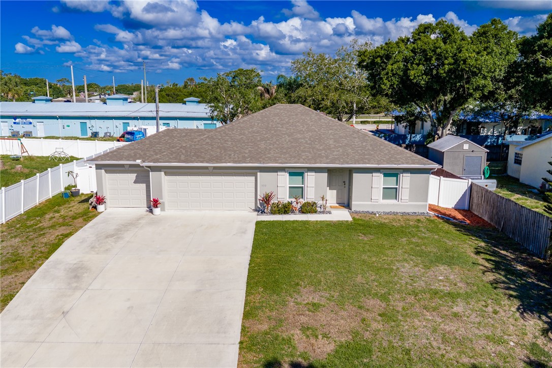 938 Clearmont Street Sebastian, FL 32958 - Photo 33 of 36 a aerial view of a house with swimming pool and a yard