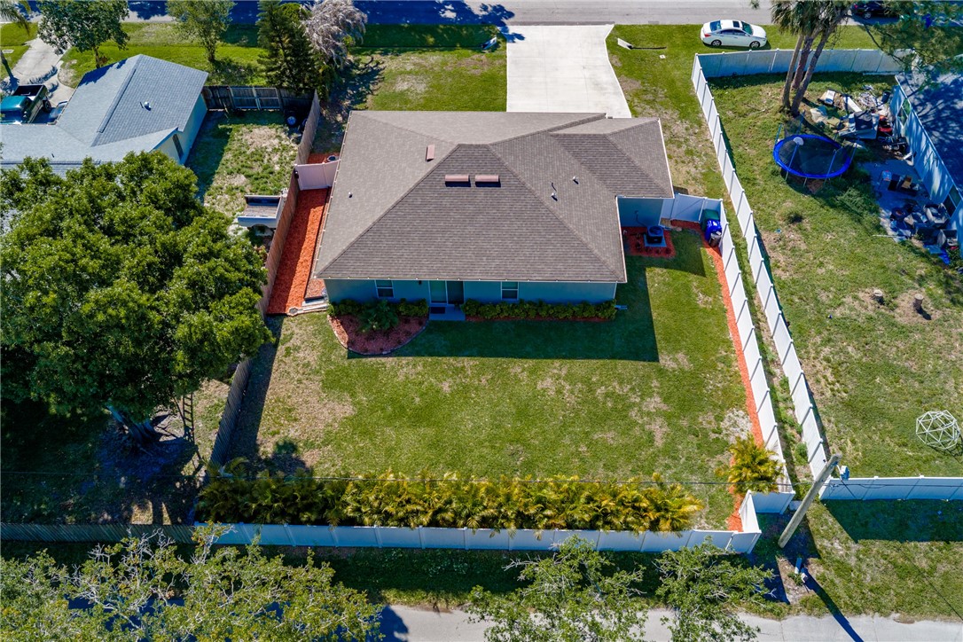 938 Clearmont Street Sebastian, FL 32958 - Photo 36 of 36 an aerial view of a house with a yard and a large tree
