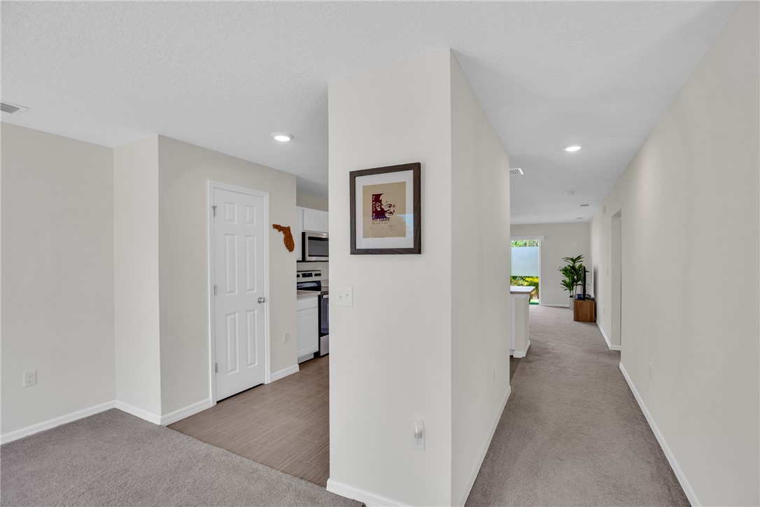 938 Clearmont Street Sebastian, FL 32958 - Photo 4 of 36 a view of a hallway with painted walls