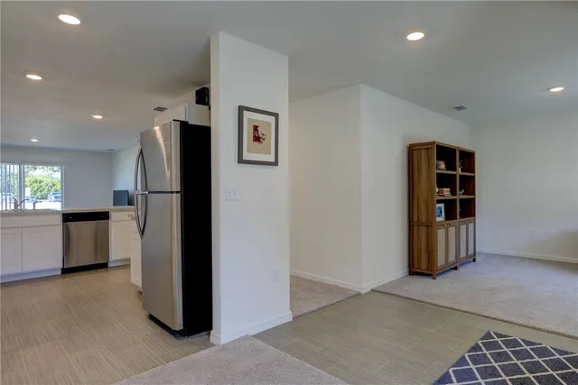 a view of kitchen with refrigerator and window