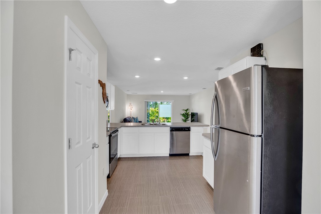 938 Clearmont Street Sebastian, FL 32958 - Photo 9 of 36 a kitchen with a refrigerator and a sink