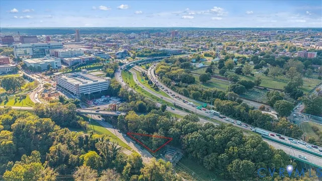 an aerial view of residential houses with outdoor space and trees