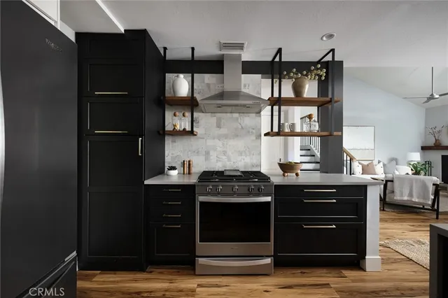a kitchen with stainless steel appliances granite countertop a stove and a refrigerator