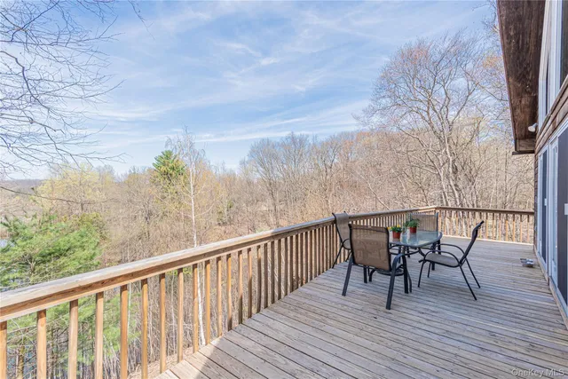 a view of a balcony with furniture and wooden floor