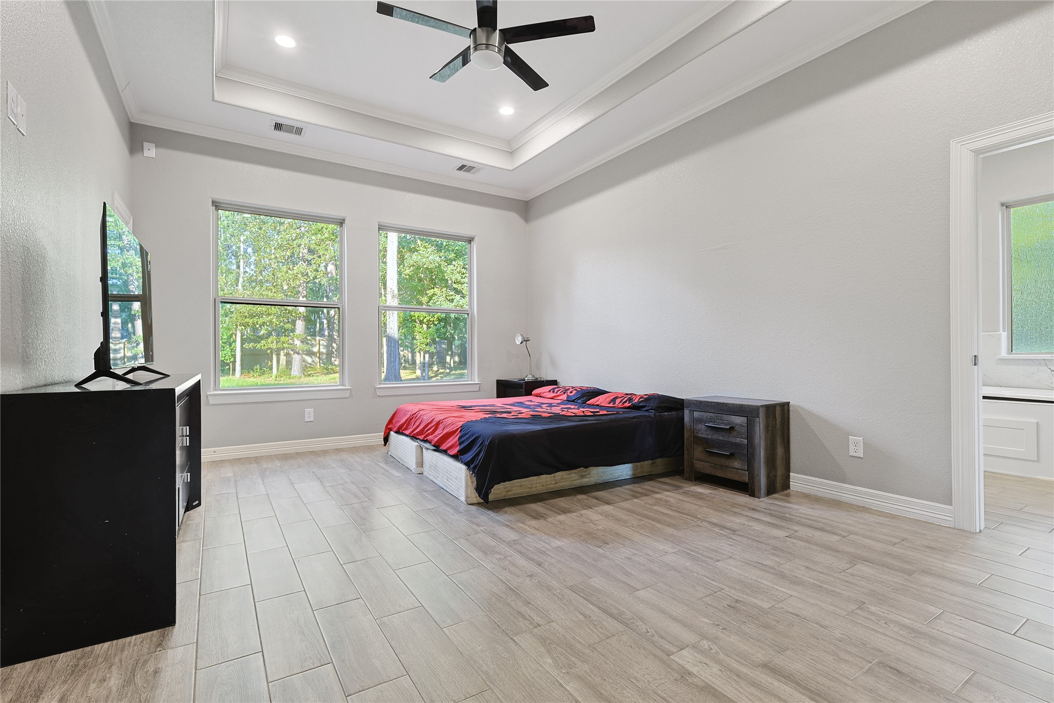 642 Parthenon Place New Caney, TX 77357 - Photo 11 of 30 a spacious bedroom with a bed and a window