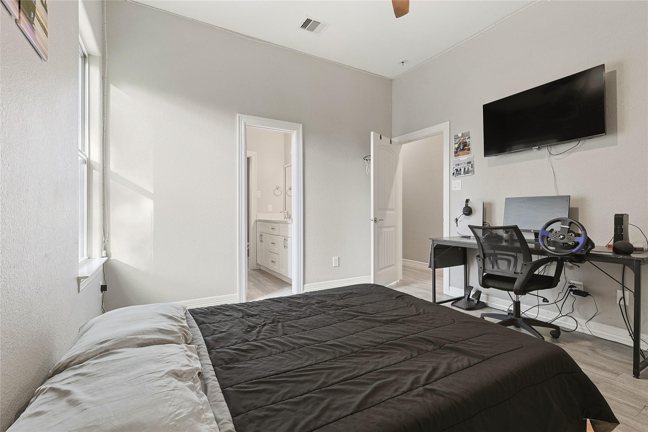 642 Parthenon Place New Caney, TX 77357 - Photo 15 of 30 a bedroom with a bed a television and a window