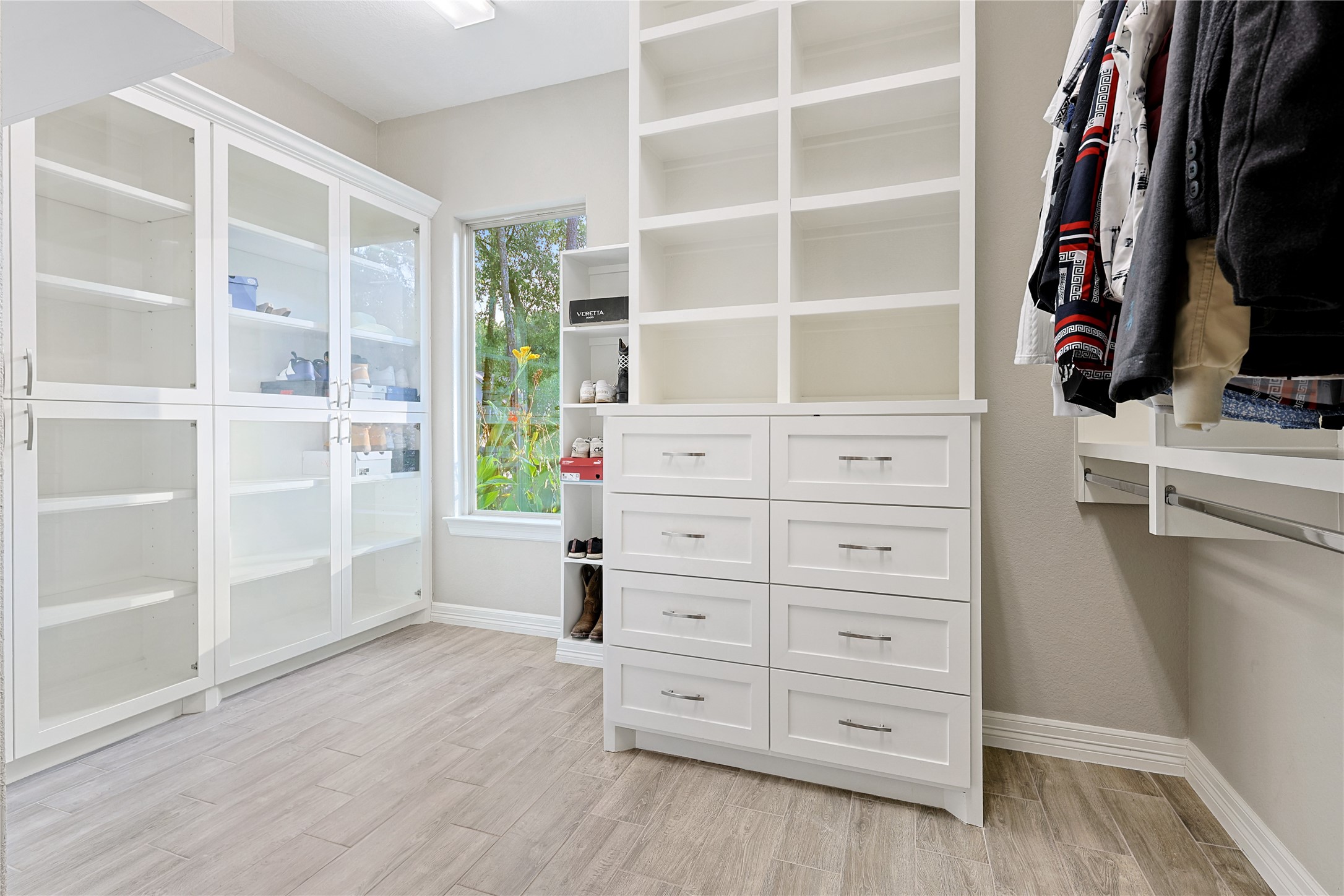642 Parthenon Place New Caney, TX 77357 - Photo 16 of 30 a view of walk in closet with clothes and shoes