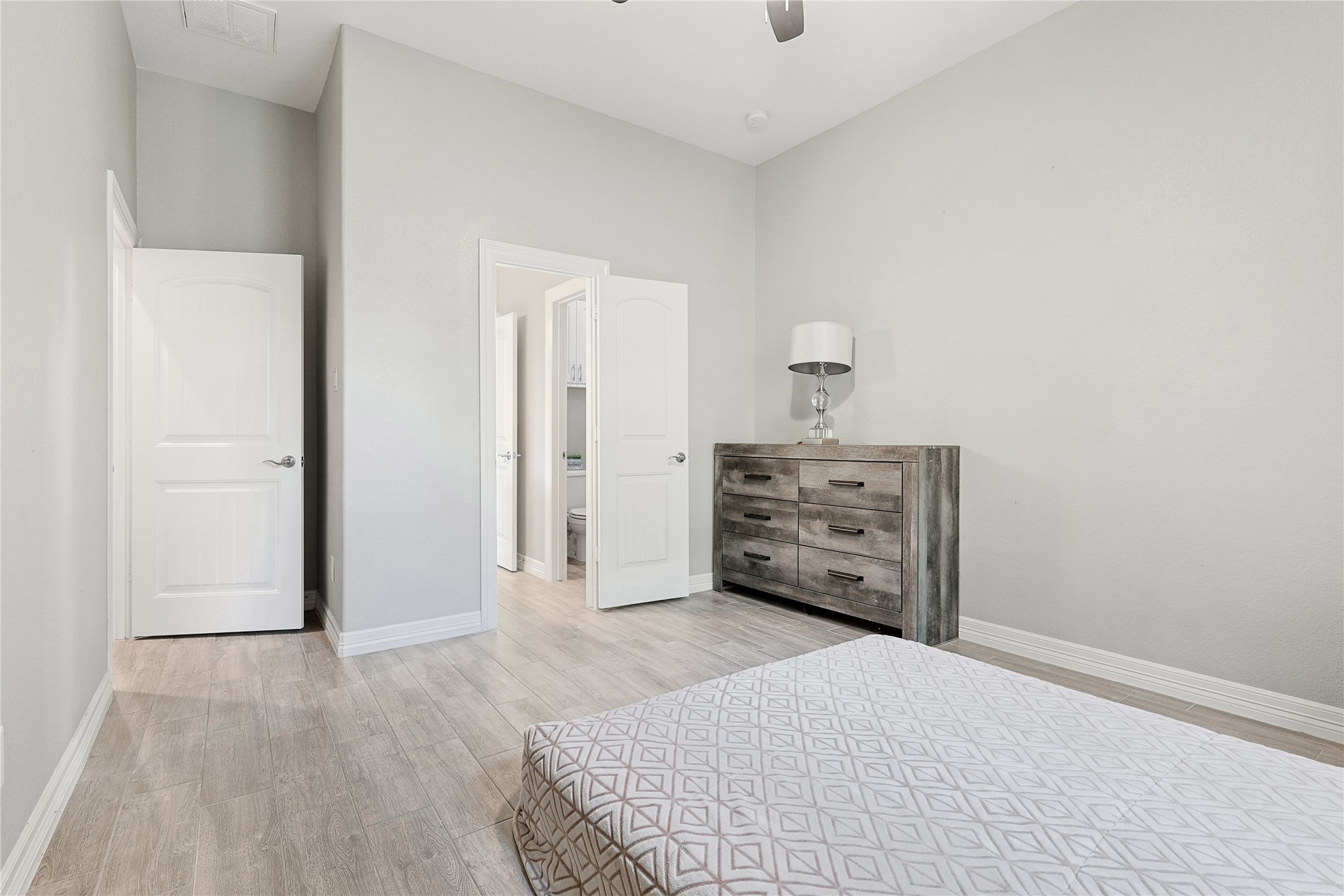 642 Parthenon Place New Caney, TX 77357 - Photo 19 of 30 a view of a bedroom with bed and dresser