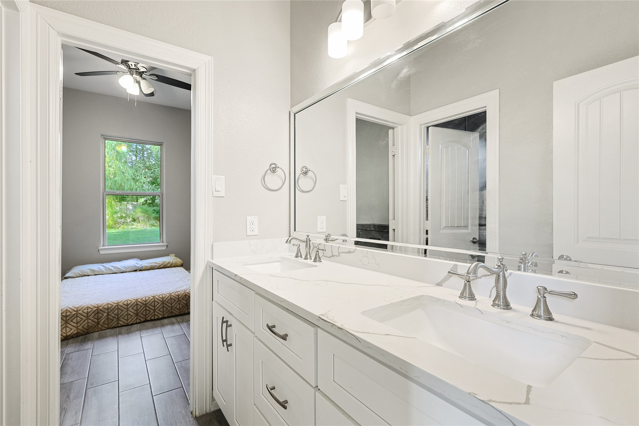 642 Parthenon Place New Caney, TX 77357 - Photo 20 of 30 a en suite bathroom with a double vanity sink and a mirror