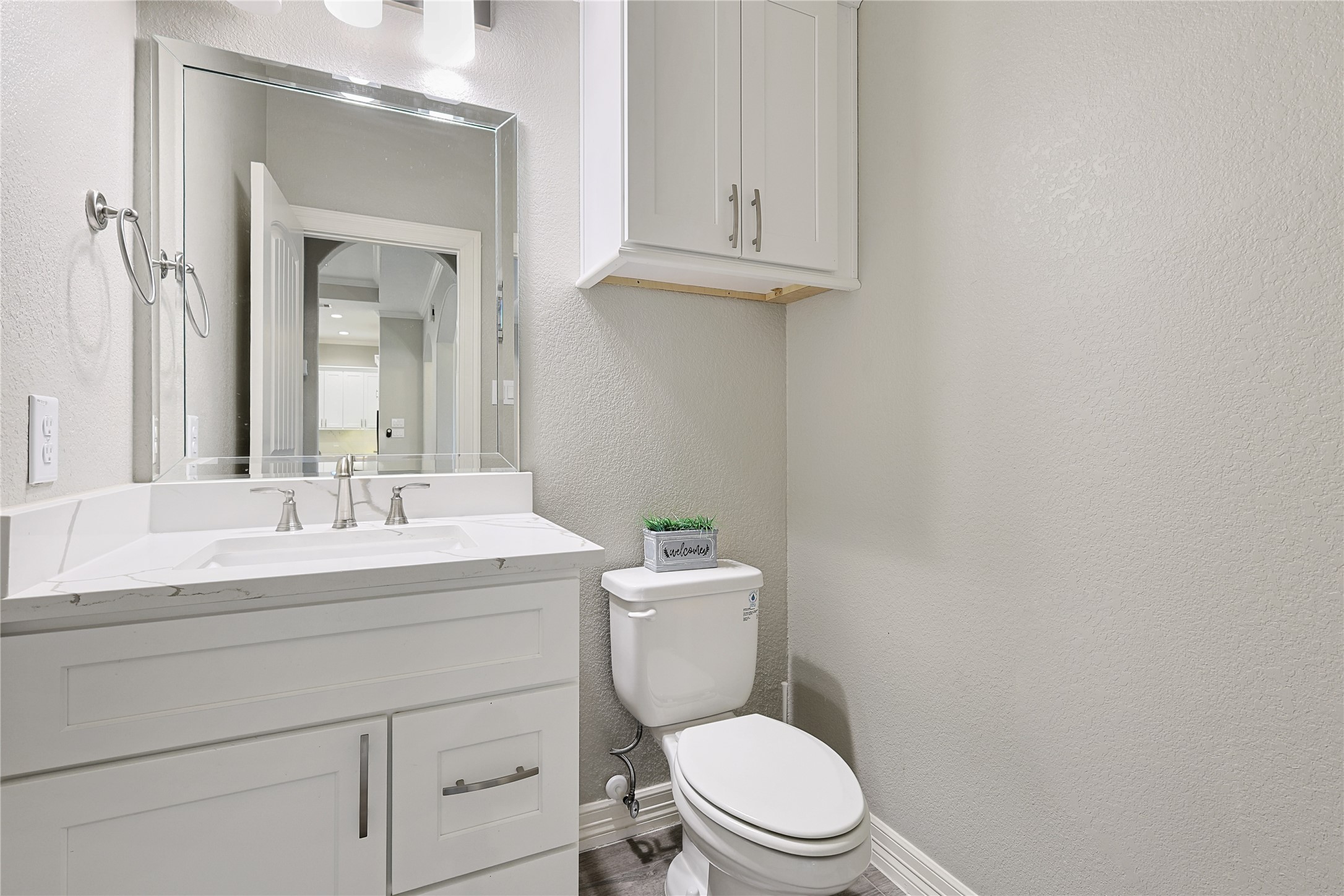 642 Parthenon Place New Caney, TX 77357 - Photo 22 of 30 a bathroom with a granite countertop toilet sink mirror and vanity