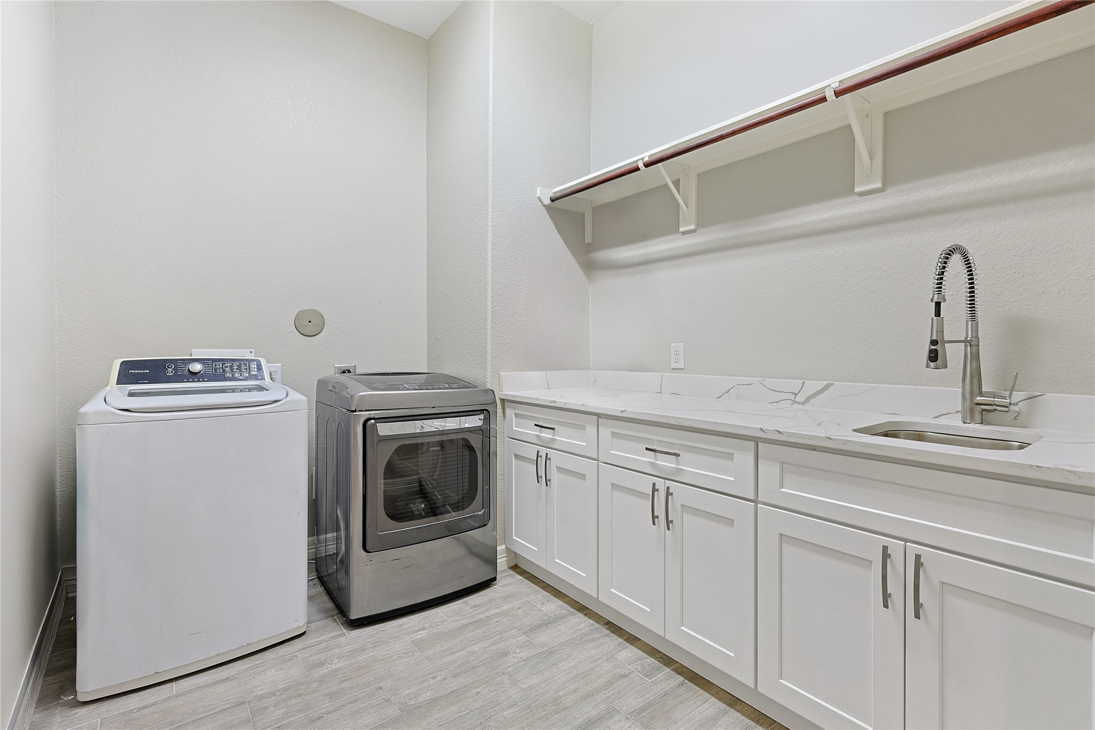 642 Parthenon Place New Caney, TX 77357 - Photo 23 of 30 a utility room with sink dryer and washer