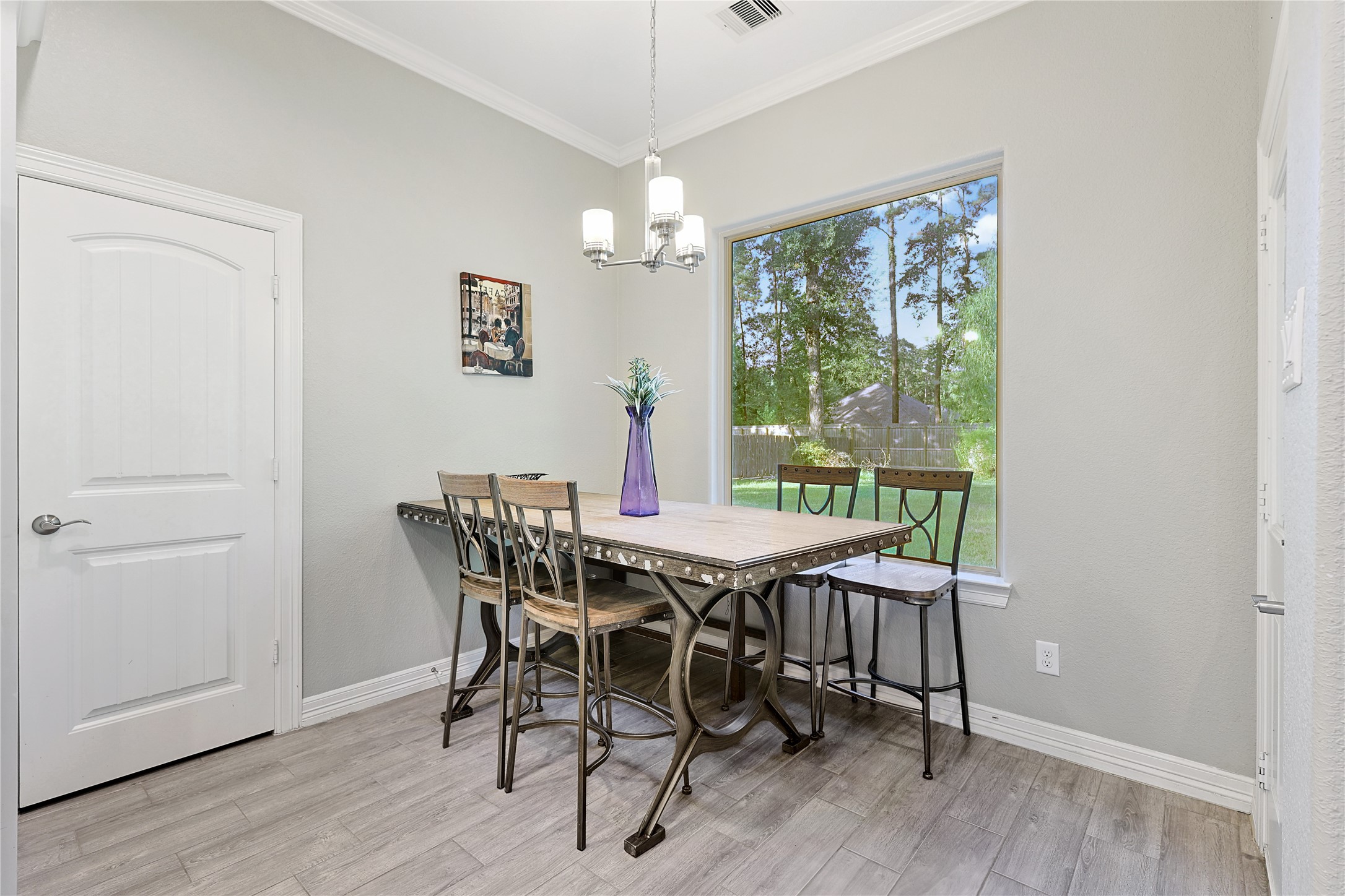 642 Parthenon Place New Caney, TX 77357 - Photo 10 of 30 a view of a dining room with furniture window and wooden floor