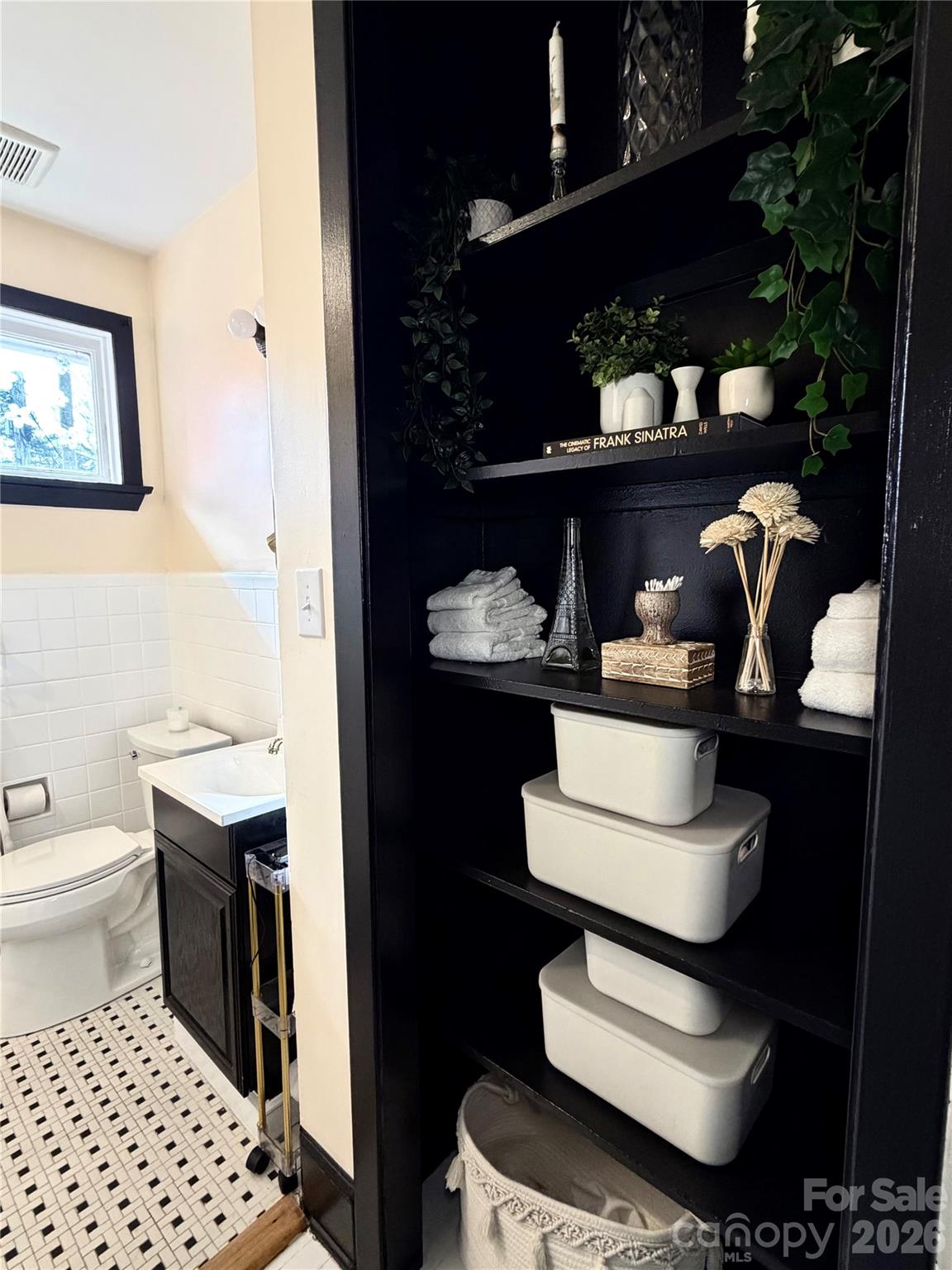 4232 Randolph Road Charlotte, NC 28211 - Photo 10 of 16 a bathroom with a sink toilet and a mirror