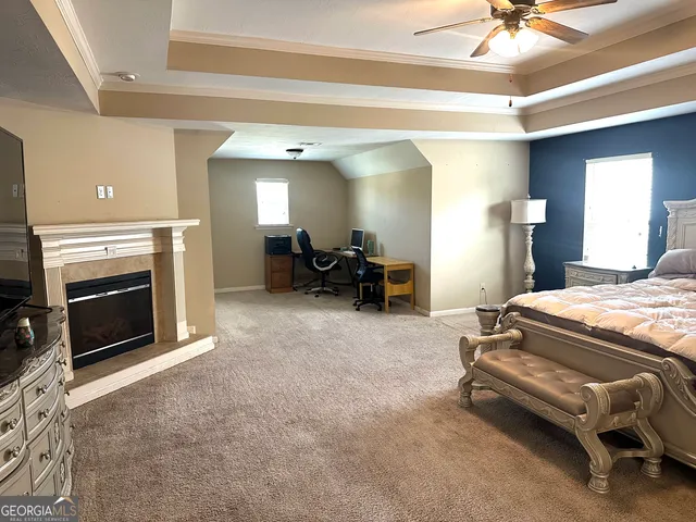 a spacious bedroom with a bed and a fireplace